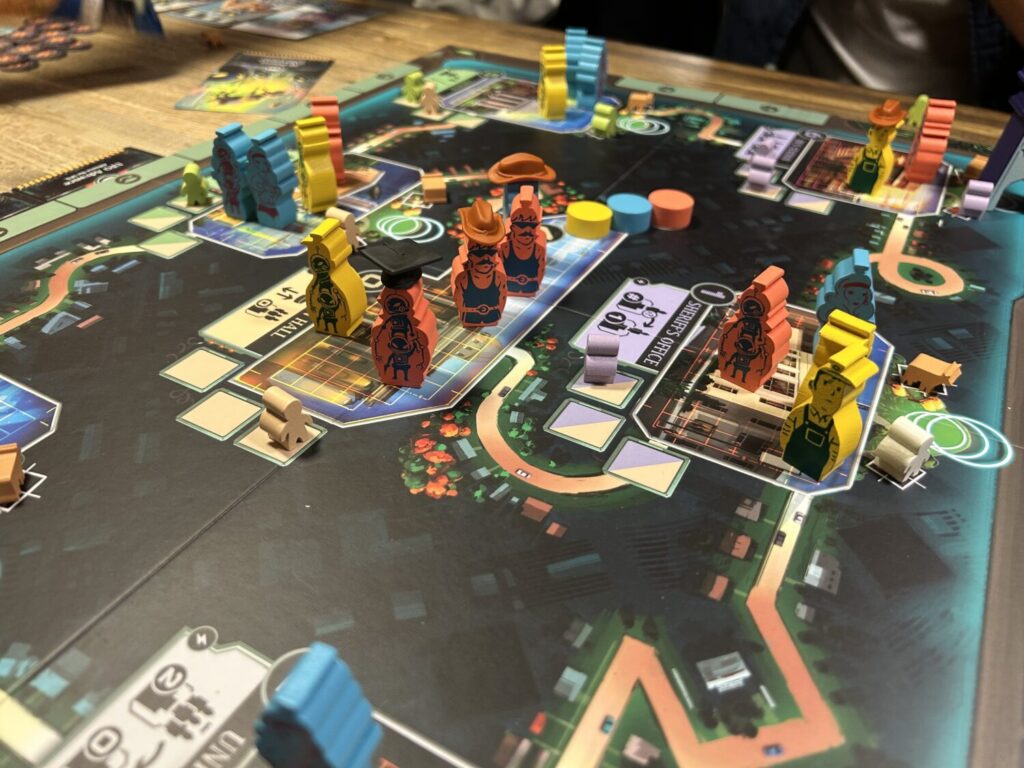 A Board filled with wooden characters, decorated with a human on one side and an alien on the other.