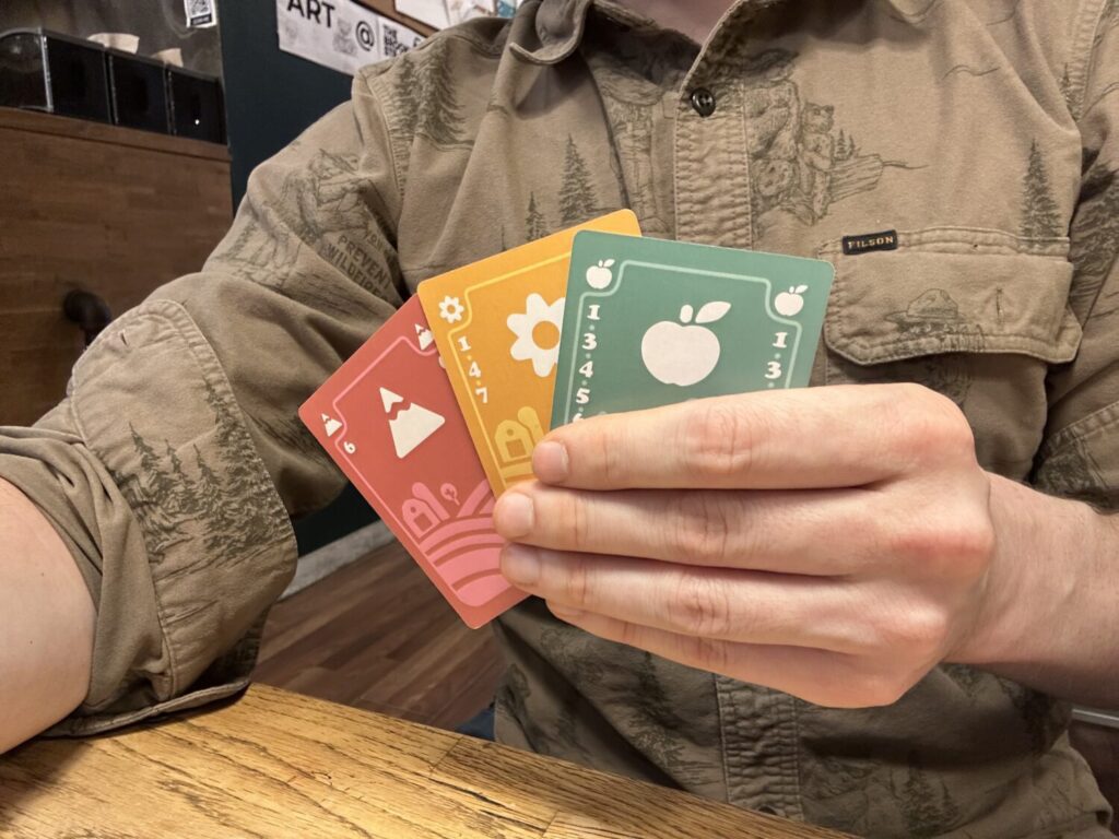 The back of a hand. The suit and color of each card are prominently displayed on the back.