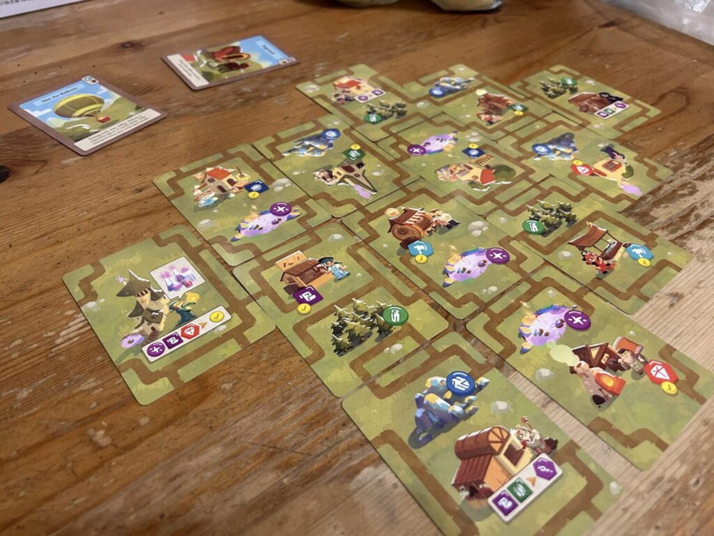 A bunch of cards laid out in a grid on a table.