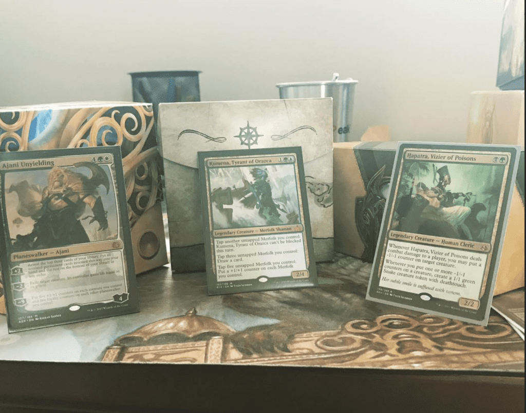 A trio of Brawl decks built circa 2018, featuring Ajani Unyielding, Kumena, Tyrant of Orazca, and Hapatra, Vizier of Poisons.