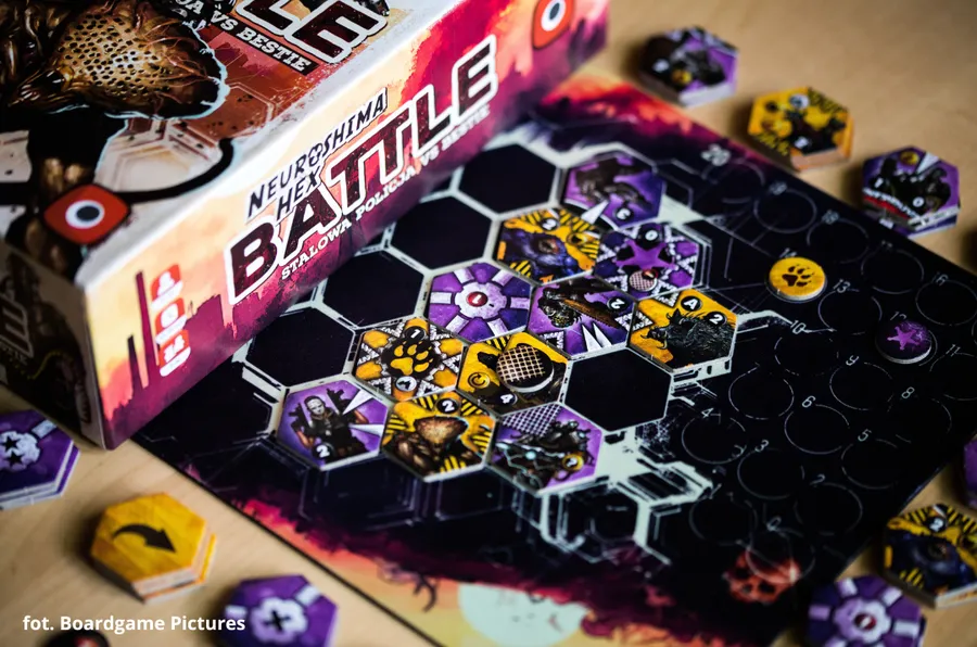 A neoprene mat divided into many hexagons, with tiles occupying many of the indicated slots.