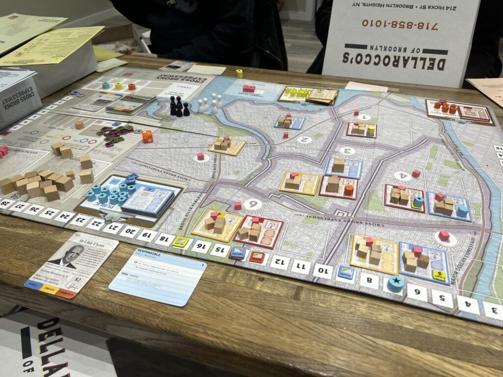 A board depicting much of The Bronx. It is covered with all variety of cubes and tokens.