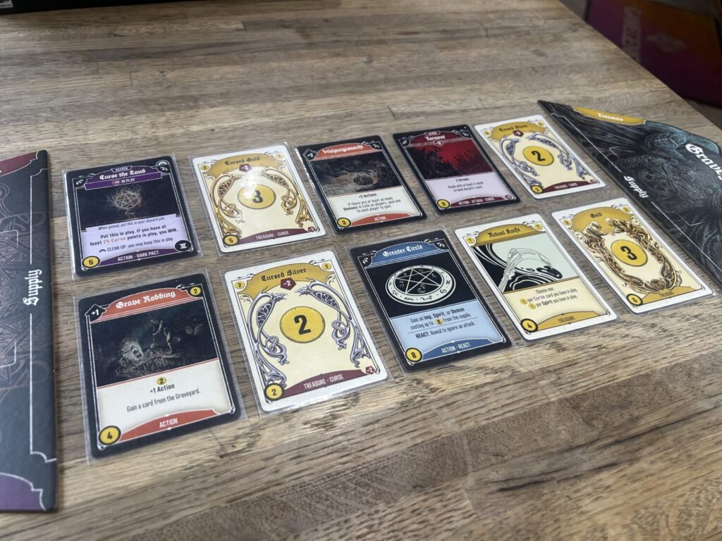 The Dark Pact market, ten cards placed between two cardboard endcaps.