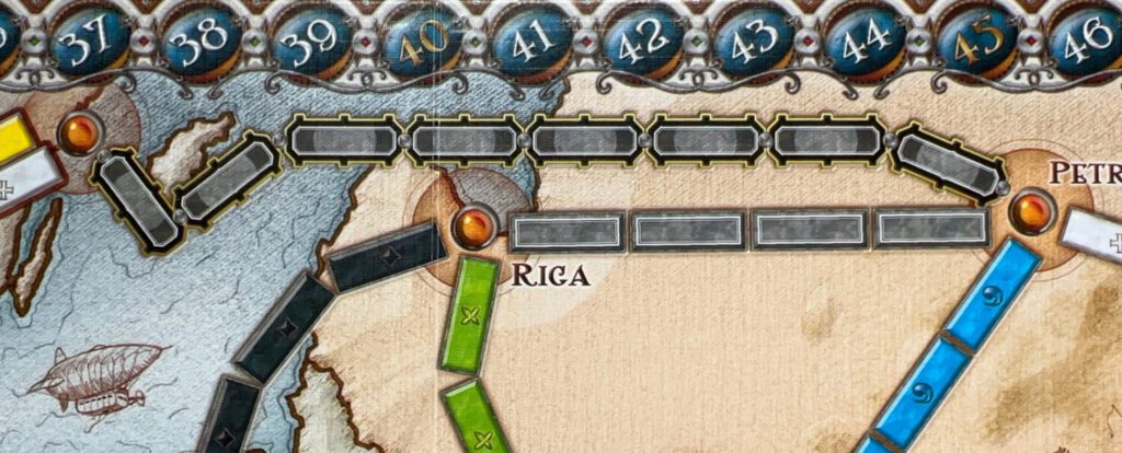 The Northernmost Tunnel. This requires a minimum of eight cards of the same color (and/or a mix of Locomotives) to lay an initial claim over. Then, the top three cards from the Train Deck are turned over. For every card of the color you used and every Locomotive card found in those top three cards, you must turn over an additional same colored card or a Locomotive. If you cannot do so, you take your trains and cards back, ending your turn.