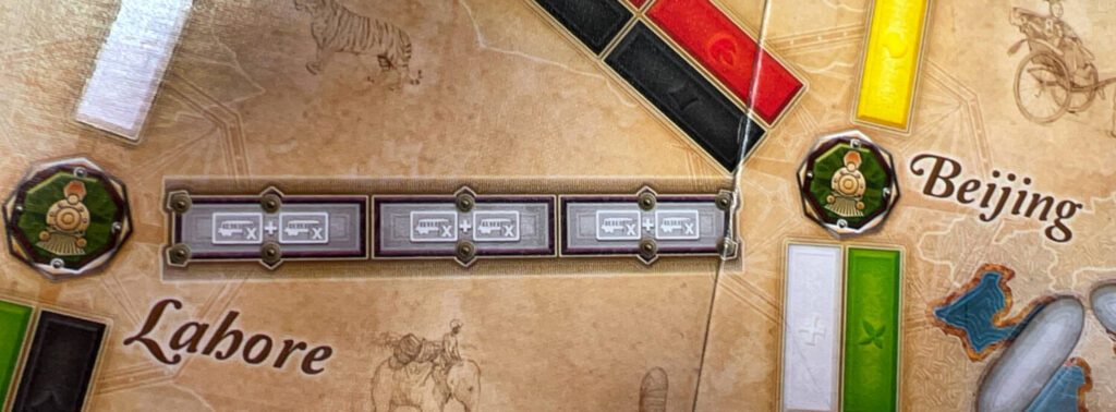 The Route from Lahore to Beijing is a Double Route. Instead of only requiring three train cards in your choice of color, each gray space is divided in two, with each showing a train car. This means you'll need double the matching train cards--six in this case-- to claim this Route.