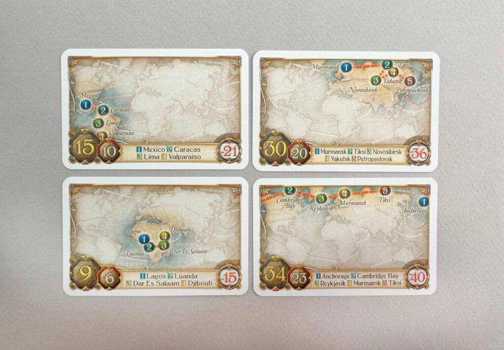 Four Tour Cards. To claim the largest number on the left, you'll need to complete your Route in the order shown. If you complete the circuit, but not in the order shown, you'll get the smaller number on the left. If you fail to connect the cities at all, the penalty is shown on the right---and is always larger than the maximum number of points the Tour Card is worth.